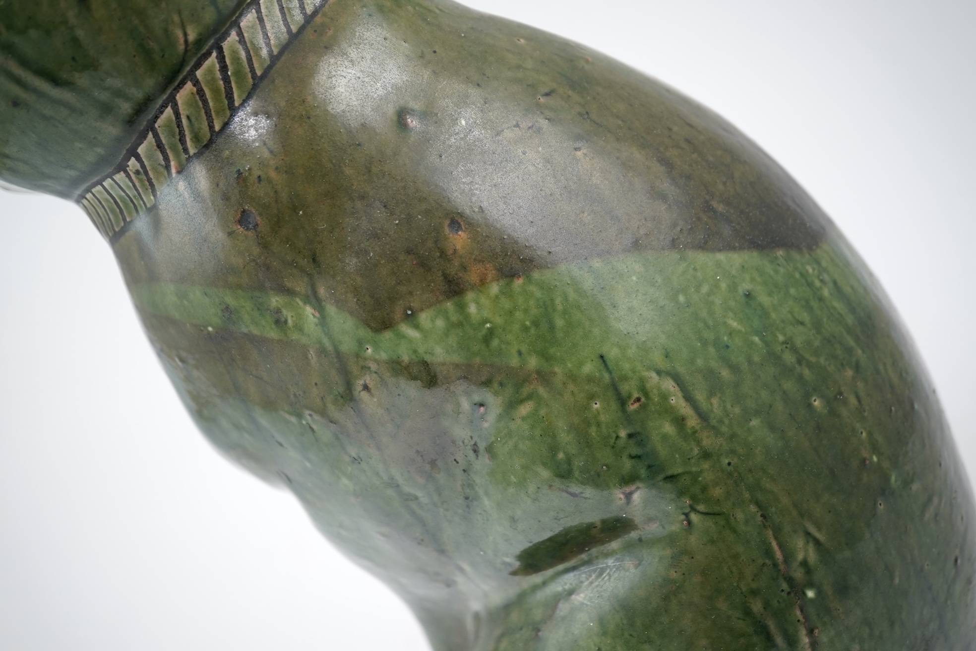 Ewenny Pottery: A large green-glazed figure of a seated cat
